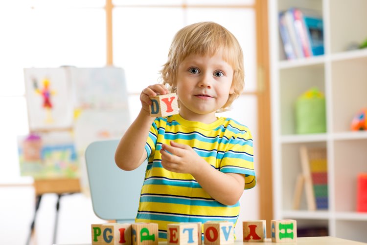 little boy playing with blocks