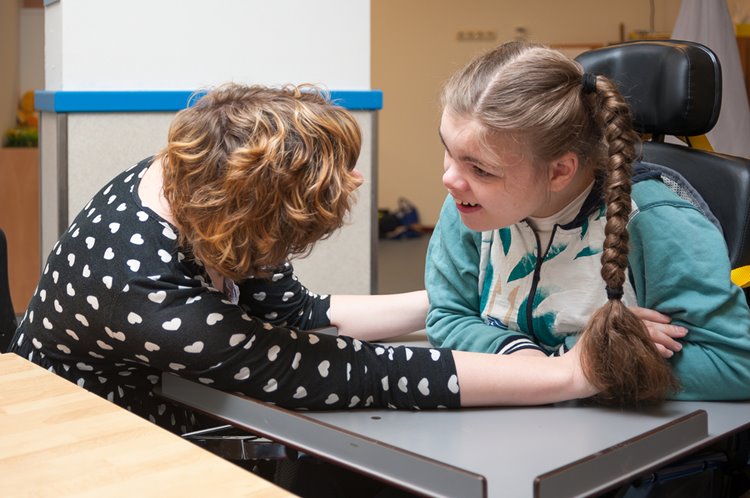 woman special needs carer with disabled young girl