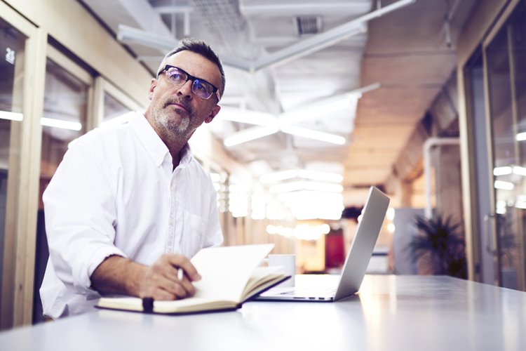senior male worker on his laptop