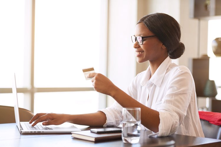 dark skinned woman paying for student loans