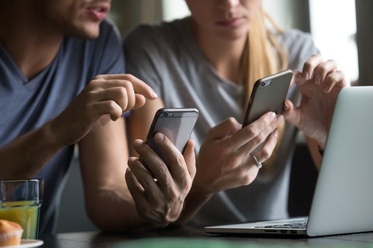 couple on smartphone discussing something