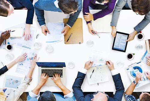 team meeting with coffee and computer tablets