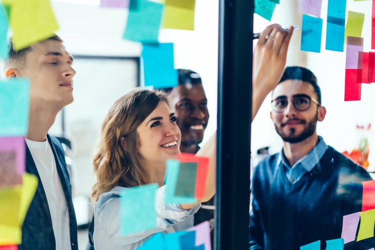 colleagues writing on sticky notes