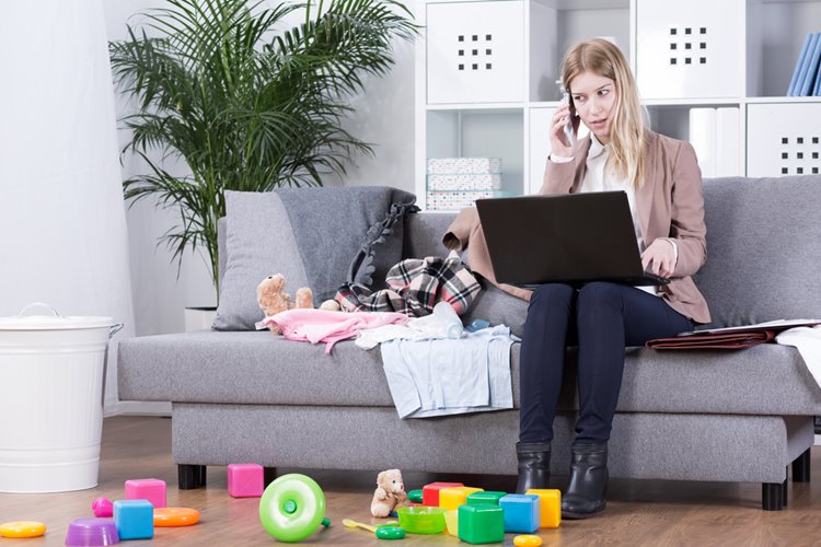young mother talking on the phone with toys on the floor
