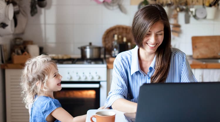 mother working from home, laughing with child