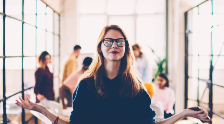 woman in glasses meditating