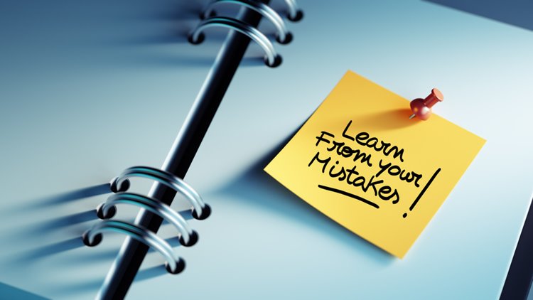 mistakes sticky note in book