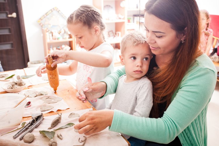 early childhood teacher helping with crafts