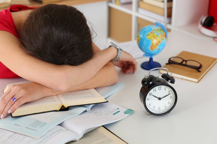 woman student asleep after studying